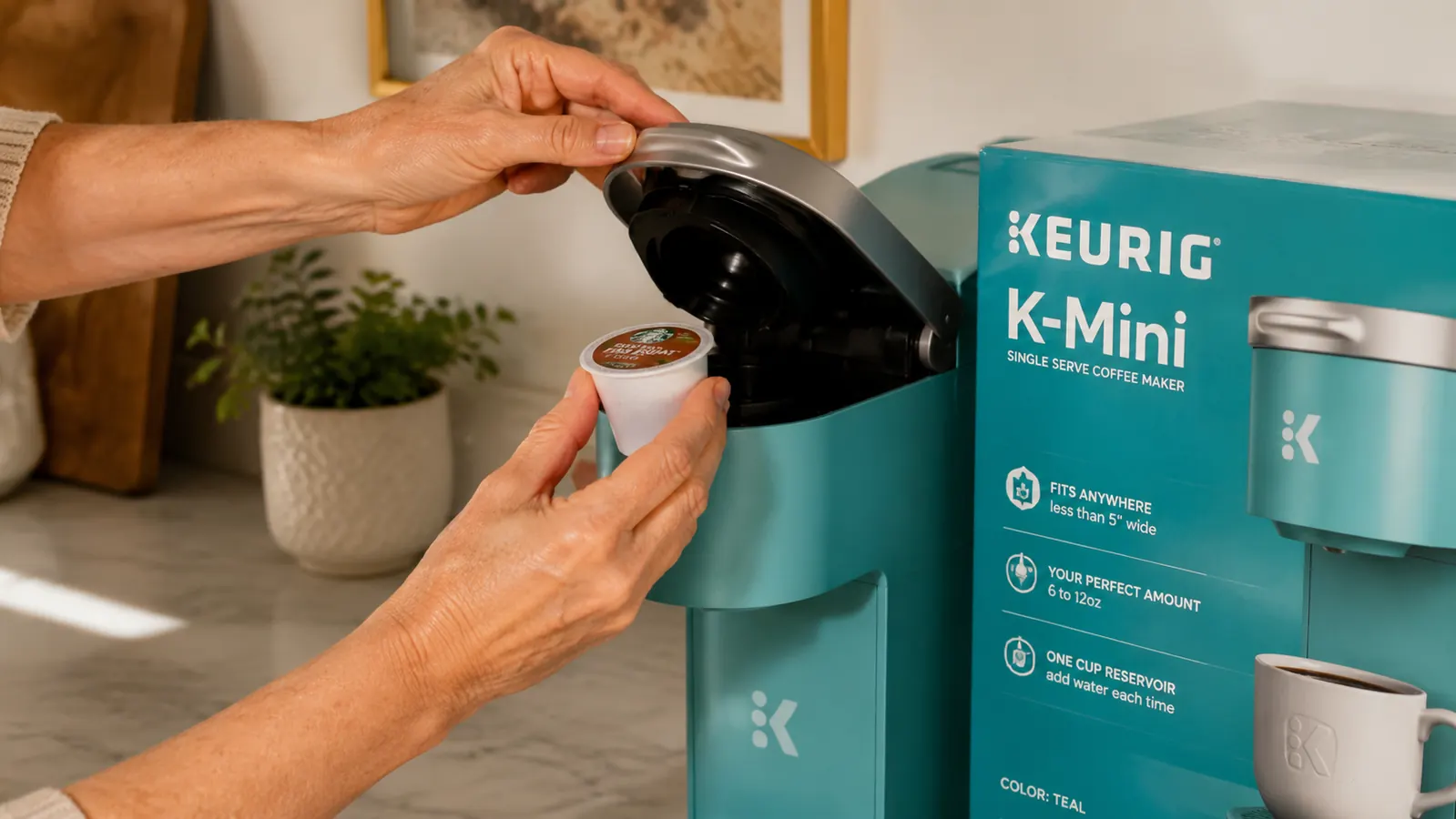 Hand placing a K-Cup pod into the Keurig K-Mini brew chamber